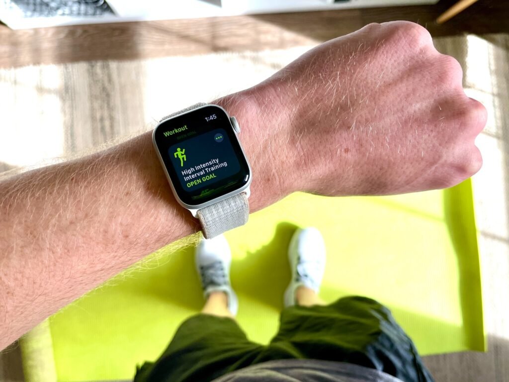 A person using a smartwatch to count their steps.
